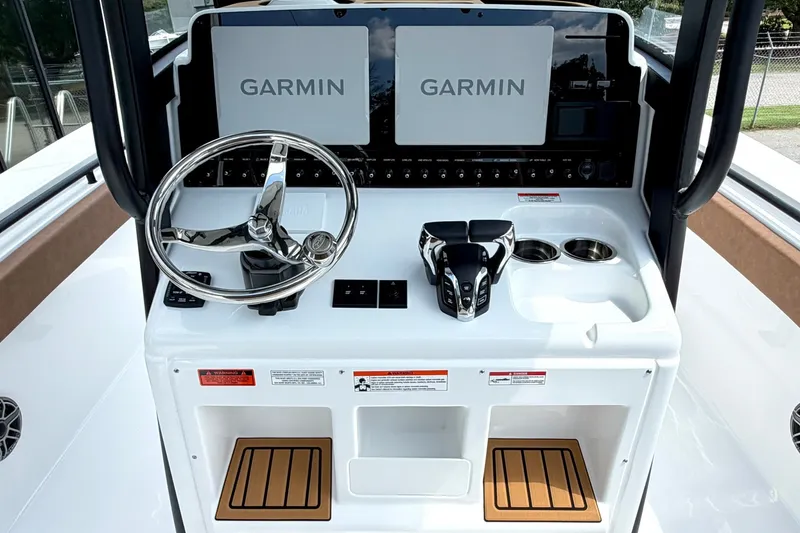 Slide: The Image of 2027 Sea Hunt Ultra 275SE boat console with dual Garmin displays and modern controls. - 14