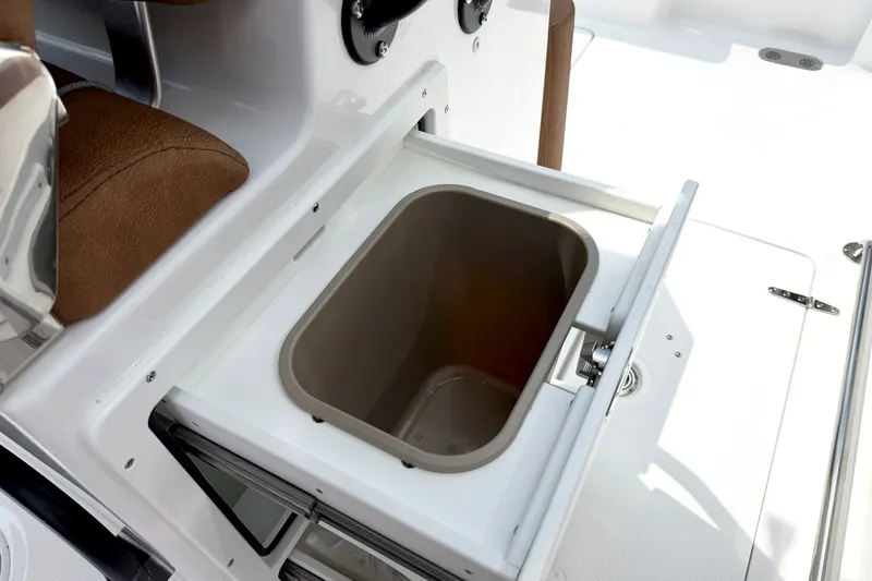 Slide: The Image of 2027 Sea Hunt Ultra 275SE boat storage compartment with open lid, showcasing interior space. - 18