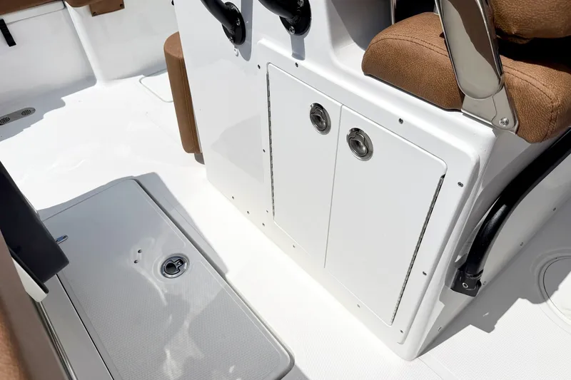Slide: The Image of 2027 Sea Hunt Ultra 275SE boat interior with storage compartments and seating. - 19