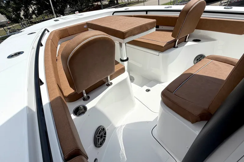 Slide: The Image of Interior of 2027 Sea Hunt Ultra 275SE boat with brown seating and table. - 22