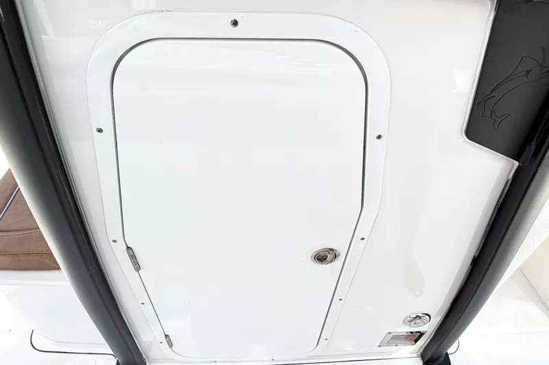 Slide: The Image of 2027 Sea Hunt Ultra 275SE boat hatch door with sleek design and secure latch. - 26