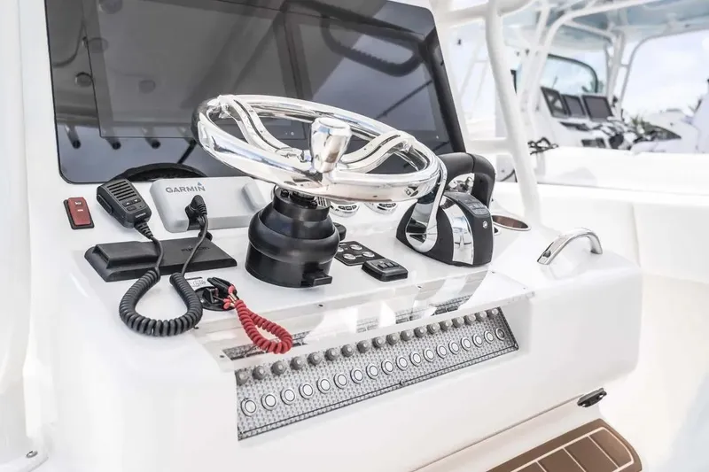 Slide: The Image of Manufacturer Provided Image: 2025 Blackwater 36 Sportfish helm with steering wheel, controls, and Garmin electronics. - 4