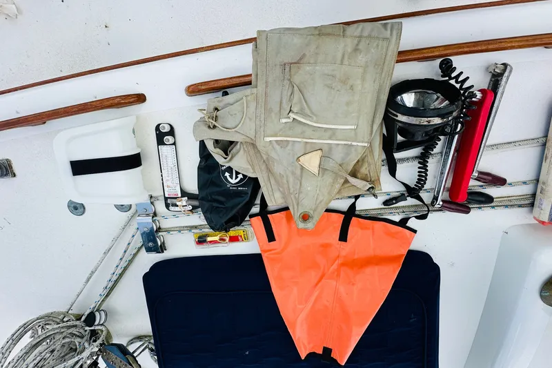 Slide: The Image of Assorted sailing gear on a 1981 Cape George 36 Cutter deck, including ropes and safety equipment. - 51
