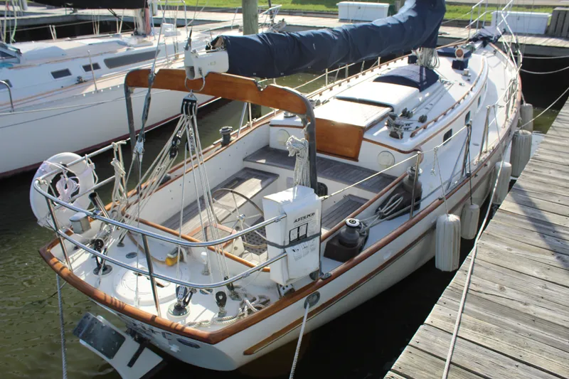 The Image of 1981 Cape George 36 Cutter sailboat docked at marina, showcasing deck and rigging. - 0