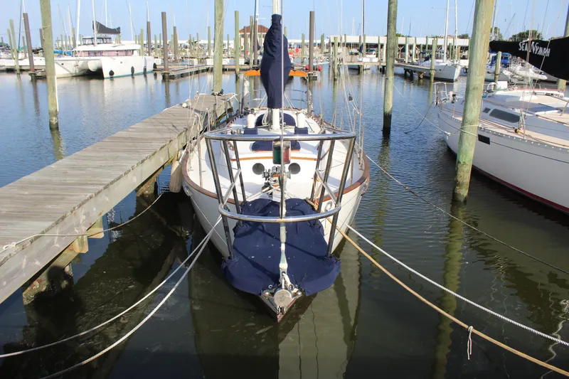 Slide: The Image of 1981 Cape George 36 Cutter docked at marina, surrounded by sailboats. - 43