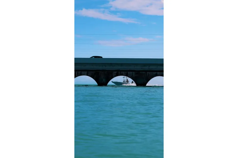 Slide: The Image of Boat under bridge, Broadwater Boatworks 25 Bay Cat 2026. - 14