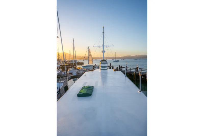Slide: The Image of Historic 1922 Blanchard Shipyard Custom boat docked at sunset, with scenic ocean view. - 16