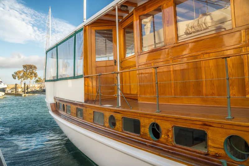 Slide: The Image of Vintage 1922 Blanchard Shipyard custom boat with polished wooden exterior docked at marina. - 96