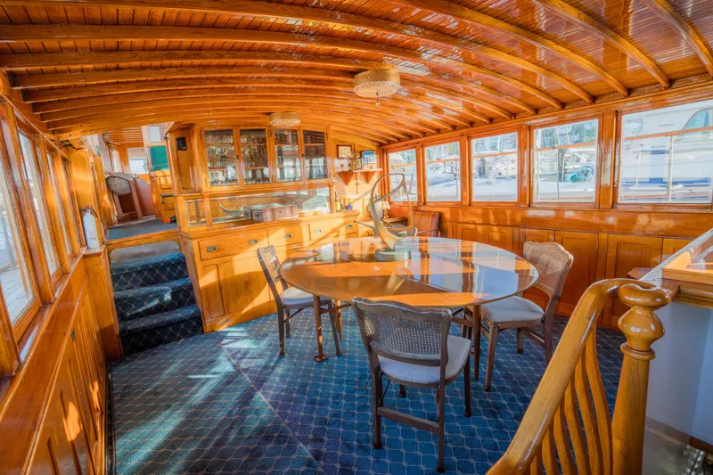 Slide: The Image of Luxurious 1922 Blanchard Shipyard custom yacht interior with elegant wood paneling and dining area. - 2