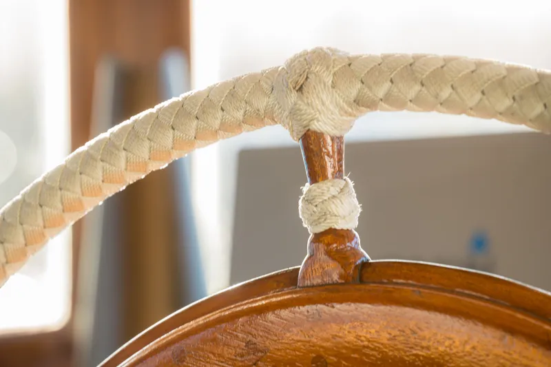 Slide: The Image of Close-up of a vintage 1922 Blanchard Shipyard Custom ship's wheel with braided rope detail. - 27