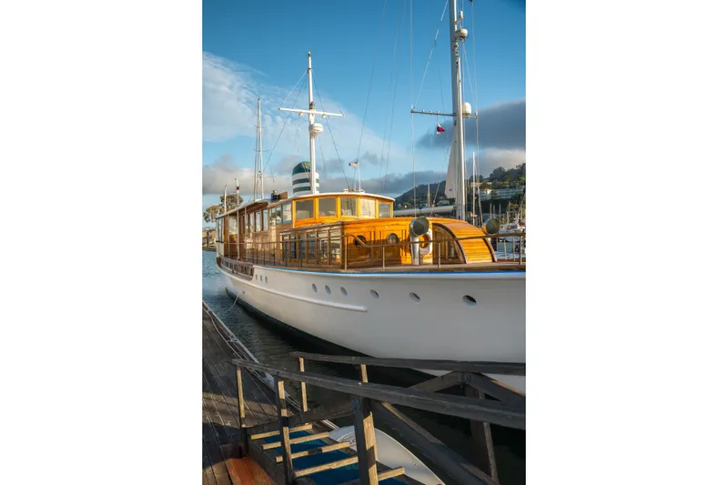 Slide: The Image of Vintage 1922 Blanchard Shipyard custom yacht docked under a clear blue sky. - 91
