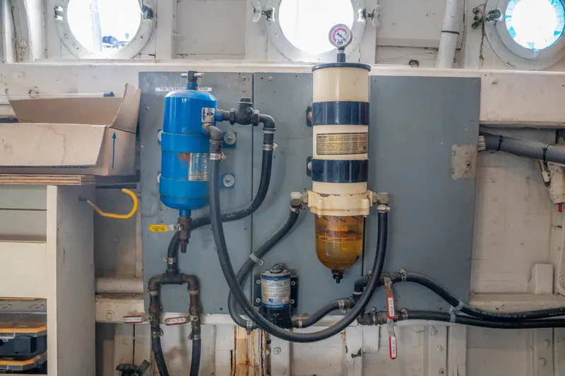 Slide: The Image of Engine room components on a 1922 Blanchard Shipyard Custom vessel, featuring gauges and pipes. - 76
