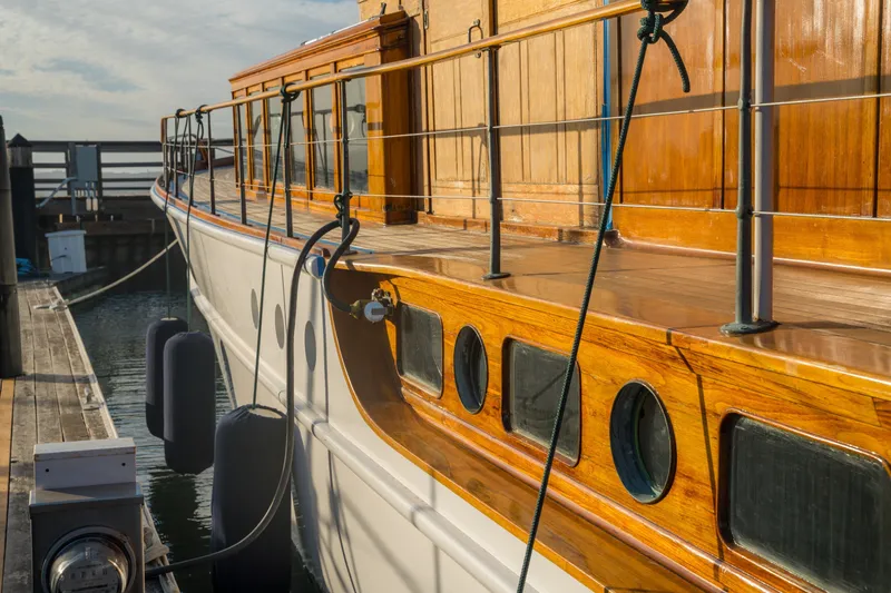 Slide: The Image of 1922 Blanchard Shipyard custom boat with polished wood finish docked at marina. - 19