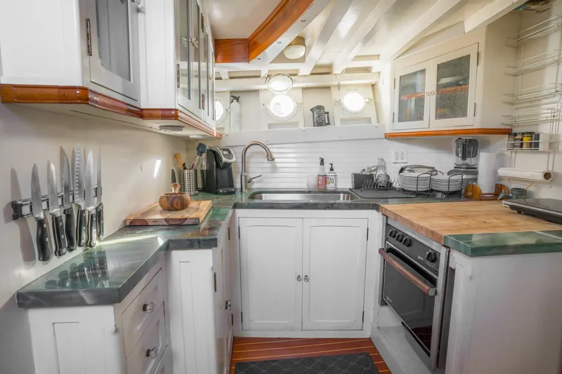 Slide: The Image of Cozy 1922 Blanchard Shipyard custom kitchen with modern appliances and nautical design elements. - 43