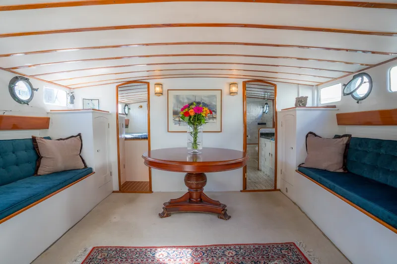Slide: The Image of Elegant 1922 Blanchard Shipyard custom yacht interior with plush seating and floral centerpiece. - 32