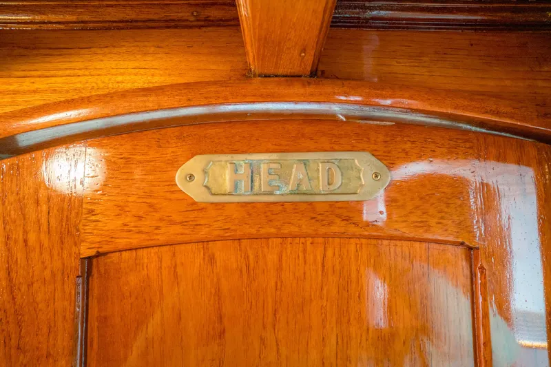 Slide: The Image of Wooden door with brass "HEAD" sign on 1922 Blanchard Shipyard custom model. - 68