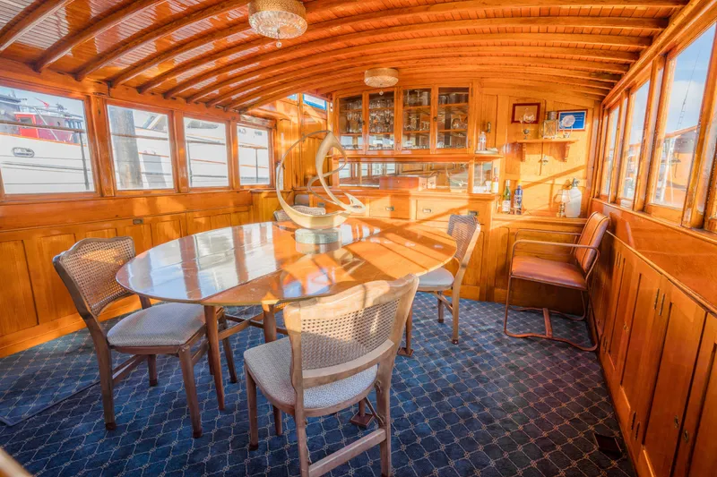 Slide: The Image of Luxurious 1922 Blanchard Shipyard custom yacht interior with elegant wood paneling and dining area. - 37