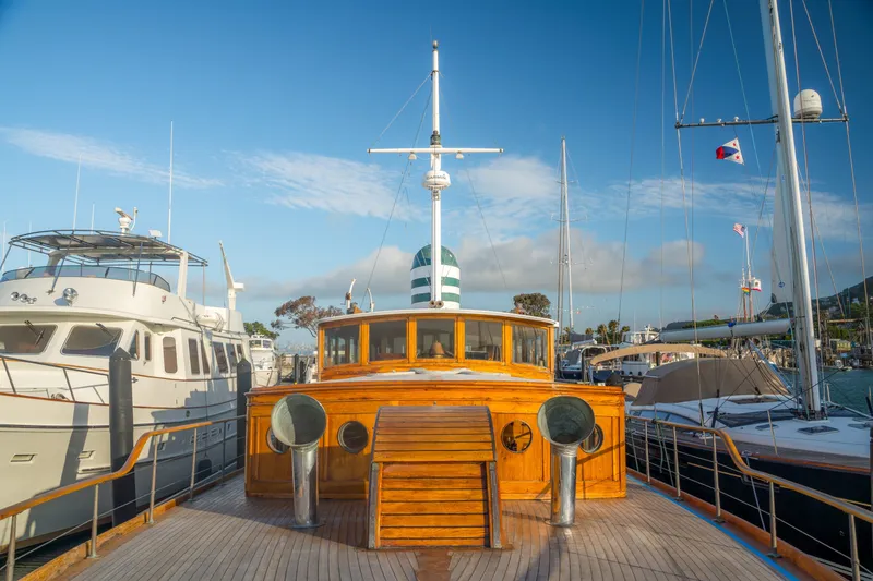 Slide: The Image of Vintage 1922 Blanchard Shipyard Custom yacht docked at marina under clear blue sky. - 15