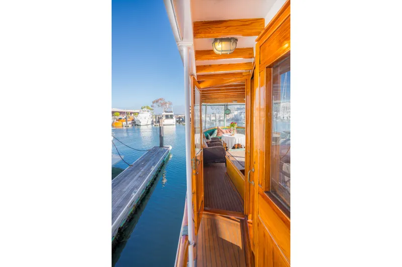 Slide: The Image of Historic 1922 Blanchard Shipyard Custom boat with wooden deck and marina view. - 20
