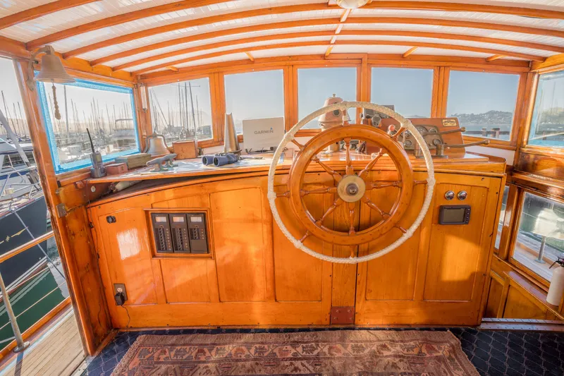 Slide: The Image of 1922 Blanchard Shipyard Custom boat helm with wooden wheel and vintage controls. - 25