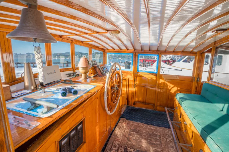 The Image of 1922 Blanchard Shipyard Custom boat interior with wooden helm and nautical decor. - 0