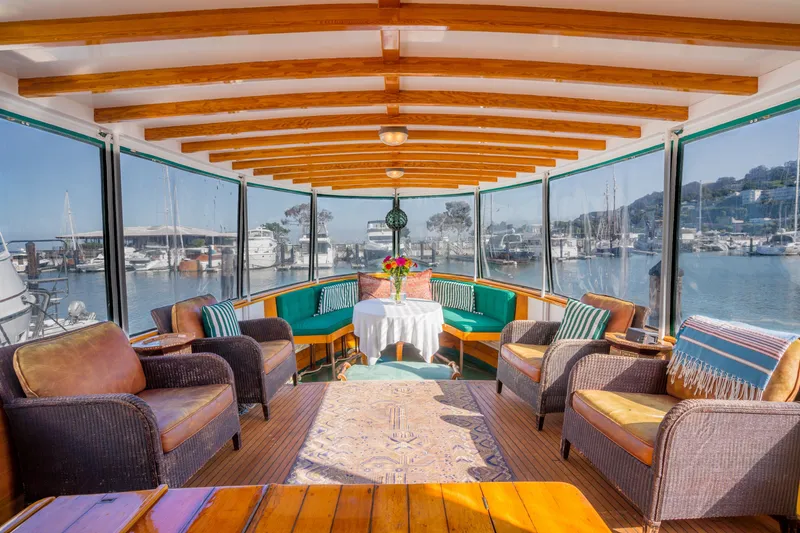 Slide: The Image of Luxurious 1922 Blanchard Shipyard custom boat interior with elegant seating and waterfront views. - 1