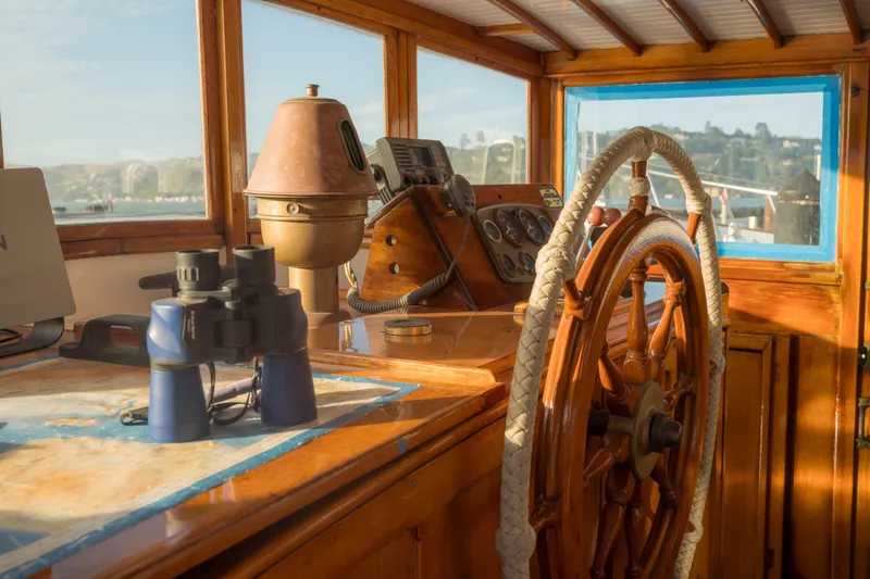 Slide: The Image of 1922 Blanchard Shipyard Custom boat helm with wooden wheel and nautical instruments. - 26