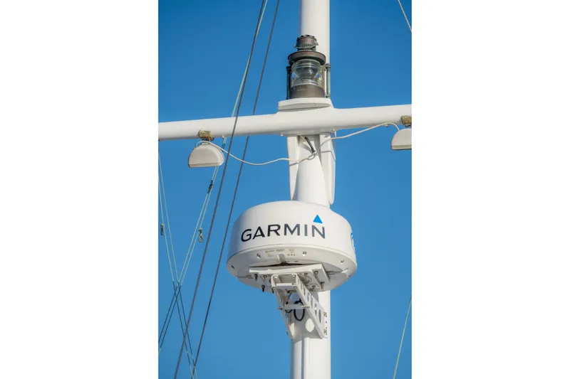 Slide: The Image of Garmin radar on 1922 Blanchard Shipyard Custom sailboat mast against blue sky. - 90