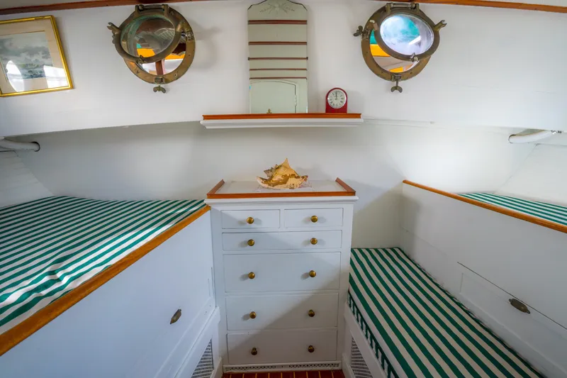 Slide: The Image of Interior of 1922 Blanchard Shipyard Custom boat with striped bedding and nautical decor. - 66