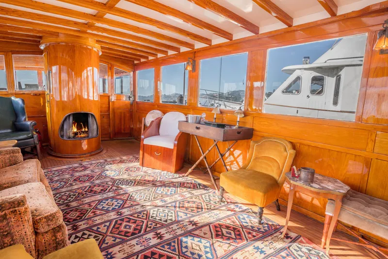 Slide: The Image of Luxurious 1922 Blanchard Shipyard custom yacht interior with fireplace and vintage decor. - 8
