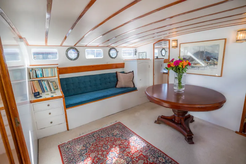 Slide: The Image of Elegant 1922 Blanchard Shipyard interior with plush seating, wooden table, and nautical decor. - 33
