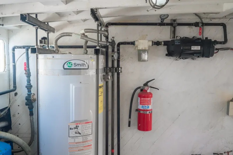 Slide: The Image of Engine room of 1922 Blanchard Shipyard vessel with water heater and fire extinguisher. - 81
