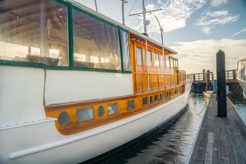 Slide: The Image of 1922 Blanchard Shipyard custom boat docked, featuring elegant wooden detailing and classic design. - 95