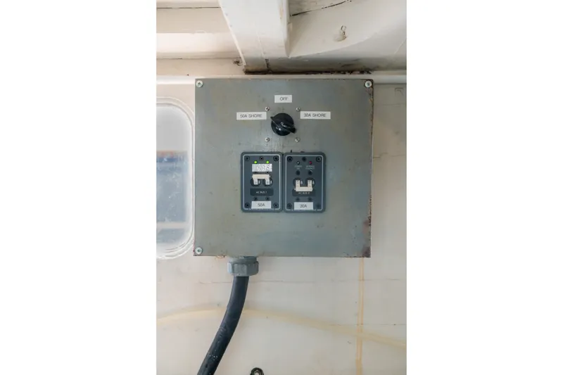 Slide: The Image of Electrical panel on 1922 Blanchard Shipyard Custom boat, featuring shore power switches. - 78