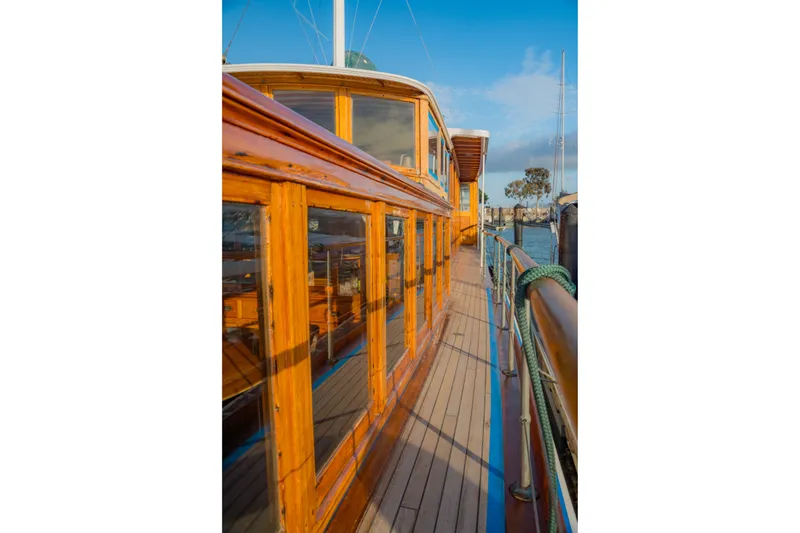 Slide: The Image of 1922 Blanchard Shipyard Custom yacht with polished wood deck and cabin, docked under blue sky. - 22
