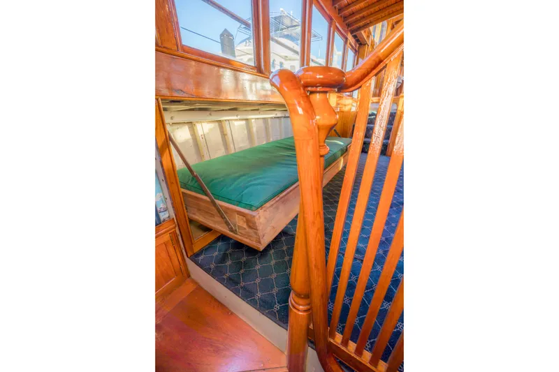 Slide: The Image of 1922 Blanchard Shipyard Custom interior with wooden details and green cushioned seating. - 39