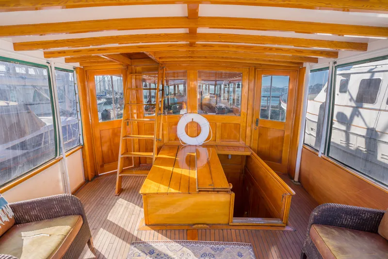Slide: The Image of Interior of a 1922 Blanchard Shipyard custom boat with wooden finishes and seating area. - 10