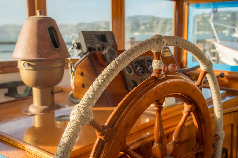 Slide: The Image of Wooden ship helm and controls on a 1922 Blanchard Shipyard custom vessel. - 100