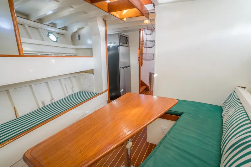 Slide: The Image of 1922 Blanchard Shipyard Custom interior with wooden table, green-striped seating, and modern amenities. - 47