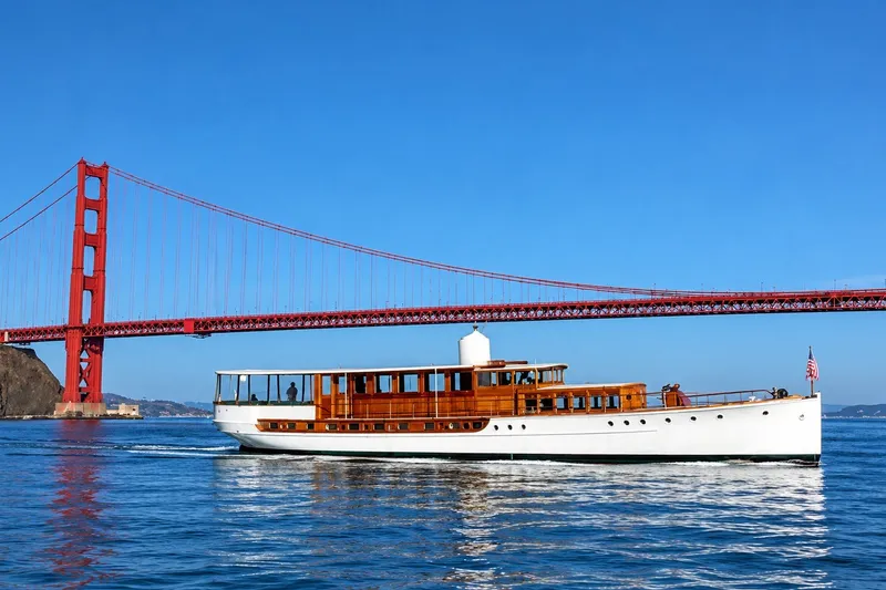 The Image of Vintage 1922 Blanchard Custom yacht cruising near Golden Gate Bridge under clear blue sky. - 0