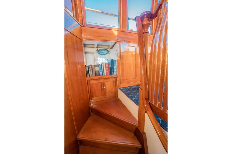 Slide: The Image of Wooden staircase with bookshelves on a 1922 Blanchard Shipyard custom boat. - 40