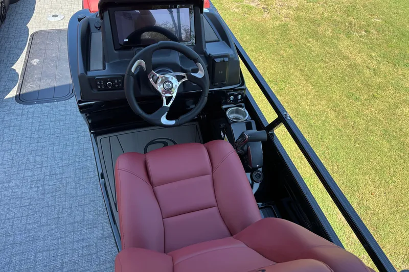 Slide: The Image of Captain's seat and helm of 2027 Regency R250DL3 boat with steering wheel and controls. - 7