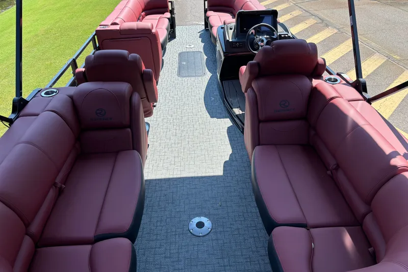 Slide: The Image of Luxurious 2027 Regency R250DL3 pontoon boat interior with plush red seating and modern helm. - 16