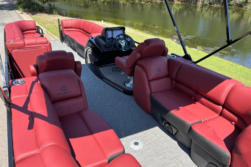 Slide: The Image of Luxurious Regency R250DL3 pontoon boat with red seating, 2027 model, by a serene lake. - 8
