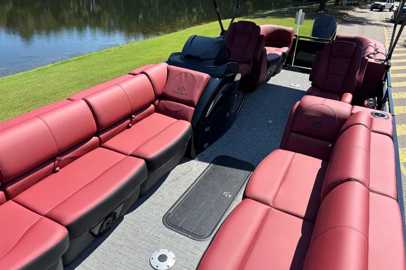 Slide: The Image of Luxurious 2027 Regency R250DL3 pontoon boat with plush red seating and spacious deck. - 6