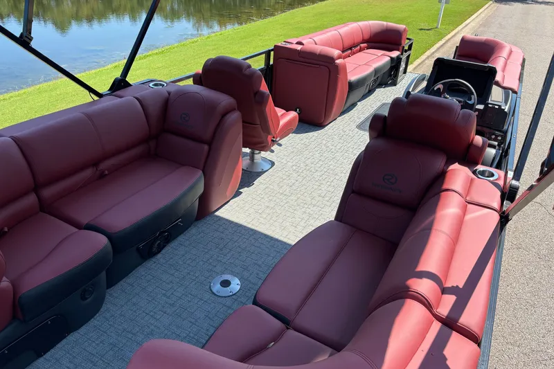 Slide: The Image of Luxurious 2027 Regency R250DL3 pontoon boat with plush red seating and spacious layout. - 15