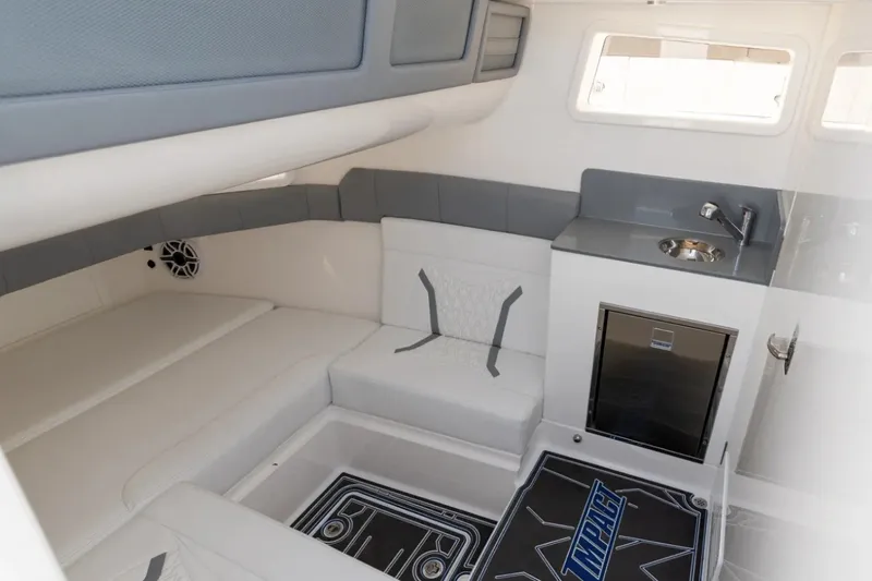 Slide: The Image of Manufacturer Provided Image: Interior of 2026 Deep Impact 449 Sport boat with seating, sink, and mini-fridge. - 14