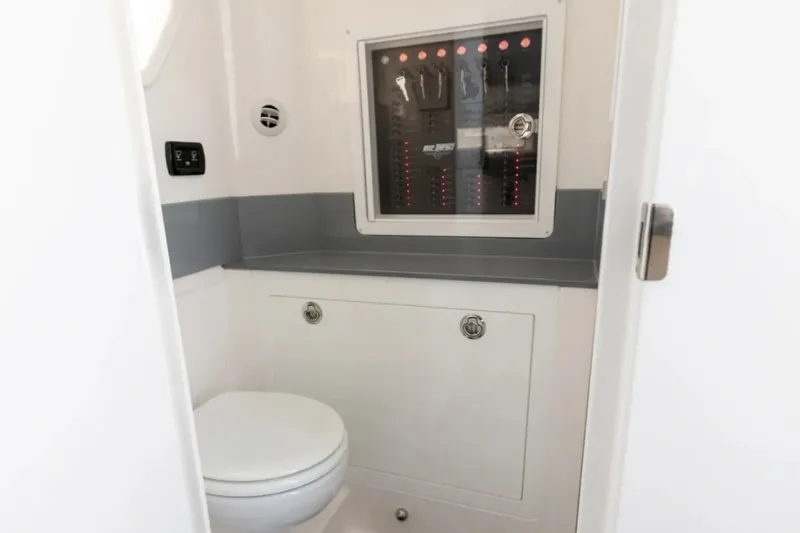 Slide: The Image of Manufacturer Provided Image: Interior of 2026 Deep Impact 449 Sport boat, featuring a compact bathroom with control panel. - 16