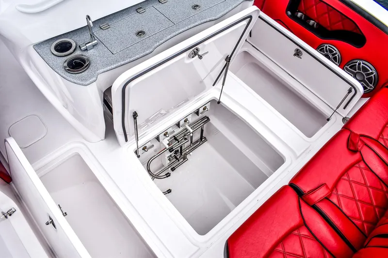 Slide: The Image of Manufacturer Provided Image: 2025 Deep Impact 399 Sport boat interior with open storage compartments and red seating. - 16