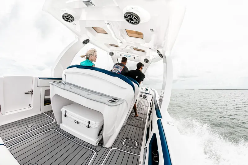 Slide: The Image of Manufacturer Provided Image: 2025 Deep Impact 399 Sport boat cruising with passengers on open water. - 11